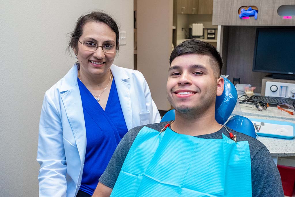 dentist with patient after teeth whitening in lancaster, tx