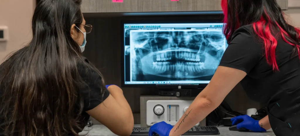 emergency dentist in Lancaster reviewing patient X-rays